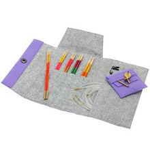 Load image into Gallery viewer, Open gray project pouch on white background with knitting needles sticking out of middle front pocket, small purple pouch sitting on right side and long strip of purple with snap button on lefts side