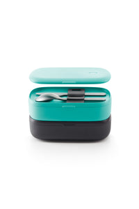 Knife and spoon in an open, teal to-go box sitting on top of a closed black to-go box.