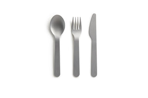 Silver spoon, fork and knife laying on a white background