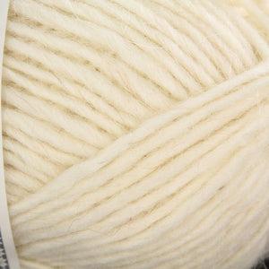 Close up of yarn color 0051. Yarn is off white/light cream in color