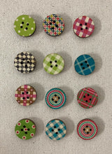 Load image into Gallery viewer, Image of several round and colorful buttons with stripe and polka dot patterns on light gray background. Each has two holes in middle