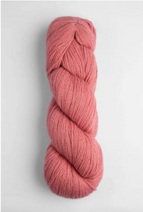 Salmon pink skein of yarn on white background