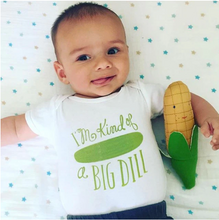 Load image into Gallery viewer, Small toddler lays on starry background with white onesie with pickle on it that reads &quot;I&#39;m kind of a BIG DILL&quot; in green. Child holds stuffed corn toy in crook of arm