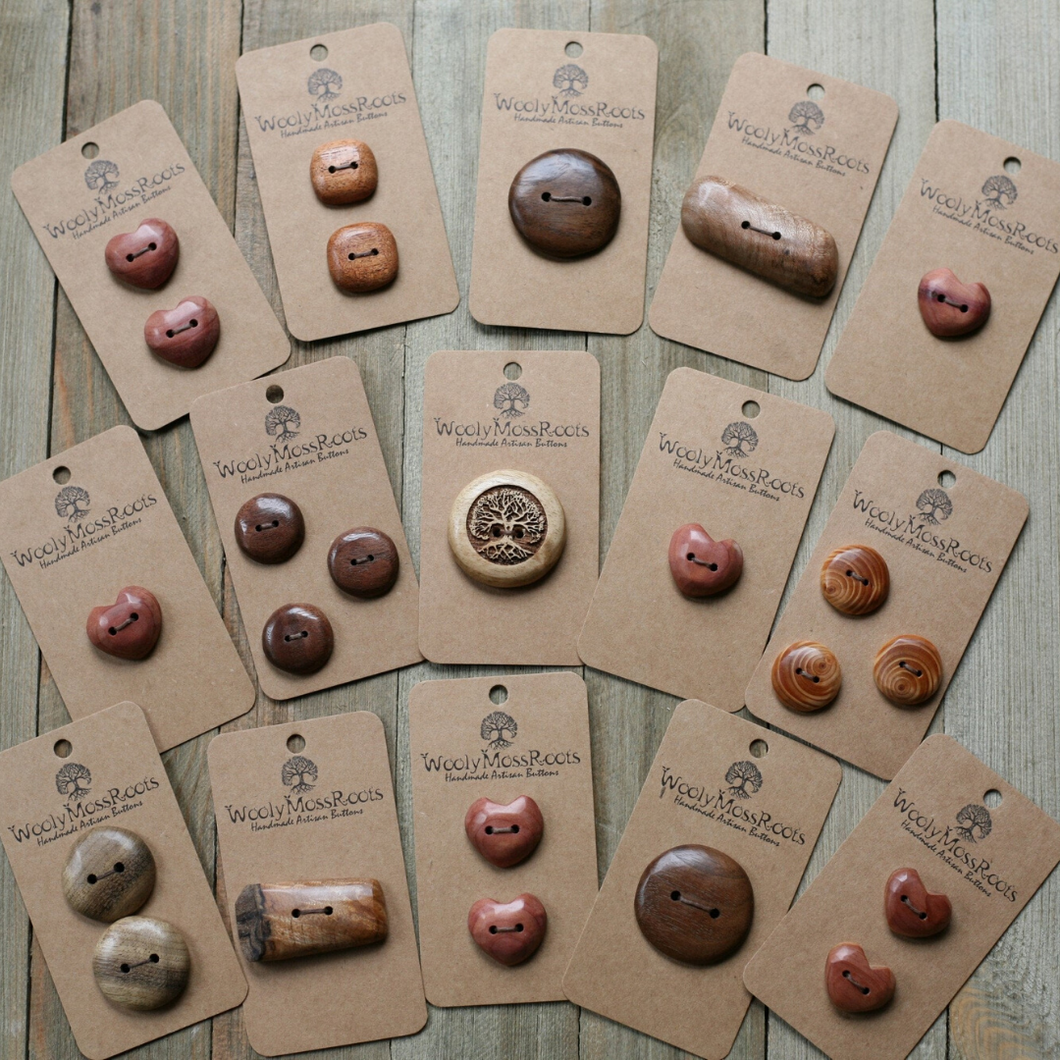 A PHOTO OF MANY HANDCRAFTED BUTTONS MADE OF VARIOUS WOODS  OF DIFFERENT SHAPES AND QUANTITIES