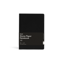 Load image into Gallery viewer, Soft black journal; Large black rectangular paper wrap half way down reads &quot;KARST&quot; &quot;Stone paper Notebook &quot;A5&quot; on right side; Small &quot;K&quot; stamped in bottom right corner of cover