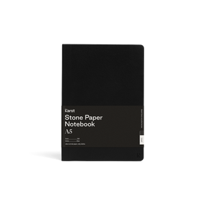 Soft black journal; Large black rectangular paper wrap half way down reads "KARST" "Stone paper Notebook "A5" on right side; Small "K" stamped in bottom right corner of cover