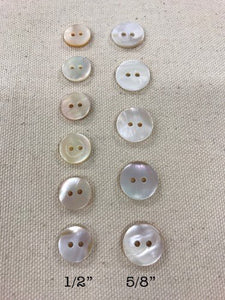 Image of two sets of round mother of pearl buttons on tan background. One set measures 1/2", other measures 5/8"