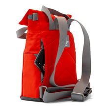 Load image into Gallery viewer, Side view of red ORI bag with gray back straps and open side zipper pocket with phone sticking out on white background