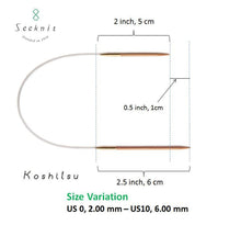 Load image into Gallery viewer, Image depicts dimensions of asymmetrical circular knitting needles on white background; Light brown needles with gold colored end connectors and clear cable connecting each laid out with shorter needle above longer needle; Shorter needle is shown to measure &quot;2 inch, 5 cm&quot; with a black line across; Longer needle is shown to be &quot;2.5 inch, 6 cm&quot; across with a black line