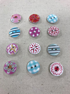 Image of several colorful round buttons with floral, stripe, and polka dot designs on them. Each has two holes in middle
